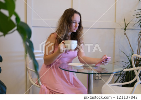 Happy young woman relax on comfortable couch at home texting messaging on smartphone, smiling girl use cellphone chatting, browse wireless internet on gadget, shopping online from home Happy young woman relax on comfortable couch at home texting messaging on smartphone, smiling girl use cellphone chatting, browse wireless internet on gadget, shopping online from home 121137842
