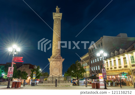 Montreal, Quebec, Canada - August 18 2021 : Night view of Nelson Monument (Nelson's Column) in Place Jacques-Cartier, Old Montreal. 121138252