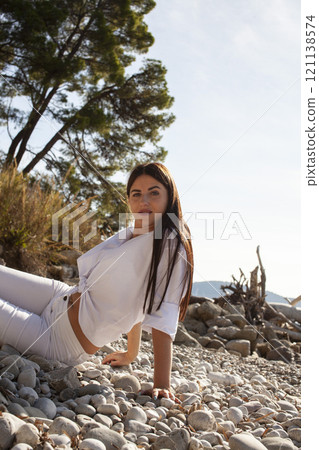 young pretty brunette woman on sea coast, lifestyle people concept close up young pretty brunette woman on sea coast, lifestyle people concept close up 121138574