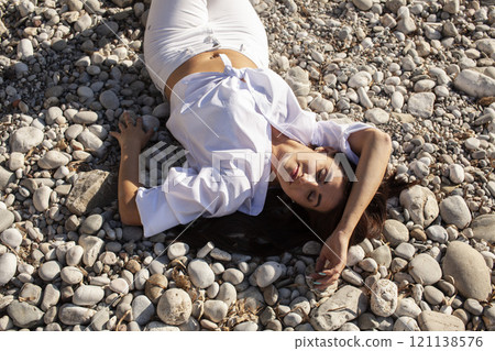 young pretty brunette woman on sea coast, lifestyle people concept close up 121138576