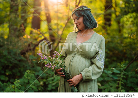 Portrait Of Fairy Pregnant Woman In Wild Forest At Sunset, Golden Hour Portrait Of Fairy Pregnant Woman In Wild Forest At Sunset, Golden Hour 121138584