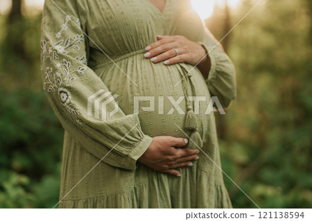 Hands of fairy Pregnant Woman In Wild Forest At Sunset, Golden Hour. Beauty of female body 121138594