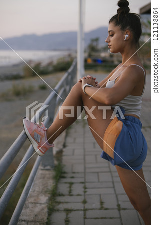 An Active Woman Engaged in Stretching Exercises Outdoors to Enhance Her Fitness Level An Active Woman Engaged in Stretching Exercises Outdoors to Enhance Her Fitness Level 121138864