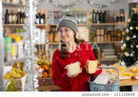 Adolescence girl examines cheese in store on eve of New Year holidays 121138899