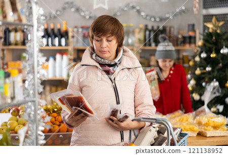 Woman is looking and choose hamon in store. 121138952