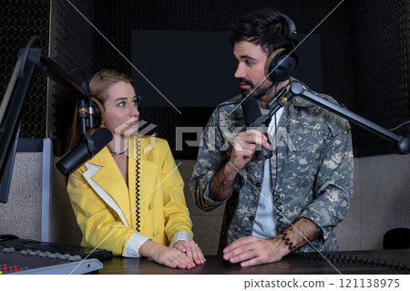 Man and woman presenting in radio station hosting live radio show Man and woman presenting in radio station hosting live radio show 121138975