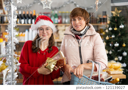 Adolescence girl with mother choose consider desserts and sweet snacks. Adolescence girl with mother choose consider desserts and sweet snacks. 121139027