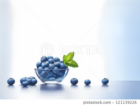 Blueberries on a transparent bowl glass on a white background with mint leaves 121139226
