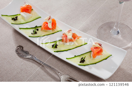 Appetizers with salmon, cheese and cucumber Appetizers with salmon, cheese and cucumber 121139546