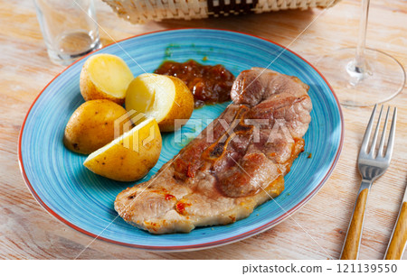 Close up of delicious baked pork with potatoes Close up of delicious baked pork with potatoes 121139550