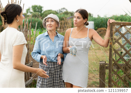 3 females talking at garden 121139957
