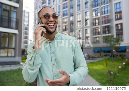 African American man having cell phone call outdoor in city street African American man having cell phone call outdoor in city street 121139975