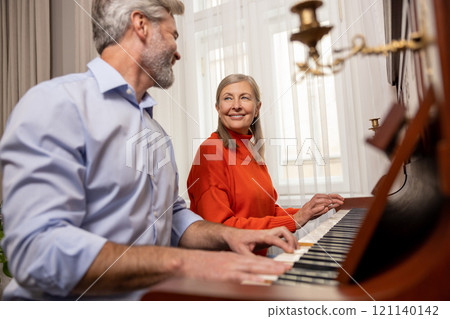 Mature woman having a music class with a male teacher 121140142