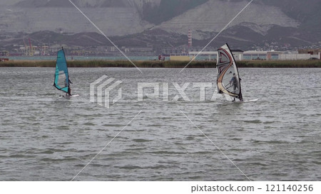 A kite surfer rides and jumps the waves the black sea 121140256