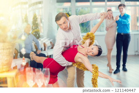 Group of people having fun celebrating Christmas and dancing waltz or tango 121140447