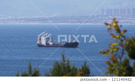 Sea freighter sailing in the middle of the ocean with big waves Sea freighter sailing in the middle of the ocean with big waves 121140482