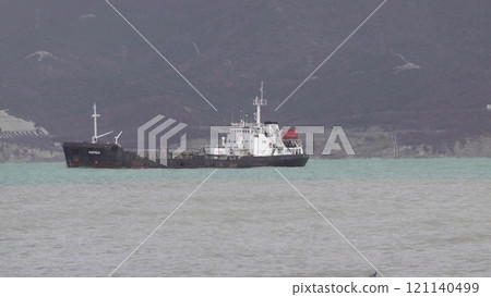 Sea freighter sailing in the middle of the ocean with big waves Sea freighter sailing in the middle of the ocean with big waves 121140499