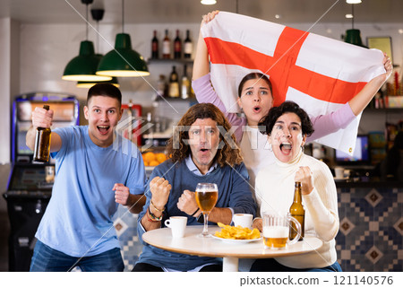 Group of people with England flag toasting with beer, having fun at party in nightclub Group of people with England flag toasting with beer, having fun at party in nightclub 121140576