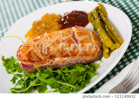 Fried duck breast Magre served with tasty sauces and arugula Fried duck breast Magre served with tasty sauces and arugula 121140632