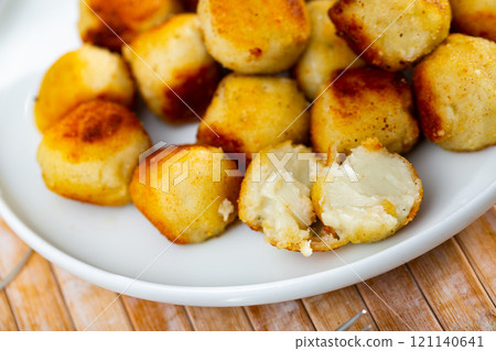 Savory deep-fried croquettes with crunchy coating and creamy cheese filling Savory deep-fried croquettes with crunchy coating and creamy cheese filling 121140641