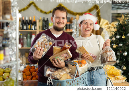Preparing for Christmas celebration - happy family buys nougat, panettone, marzipan, panellets Preparing for Christmas celebration - happy family buys nougat, panettone, marzipan, panellets 121140922
