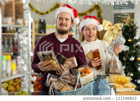 Preparing for Christmas celebration - happy family buys nougat, panettone, marzipan, panellets Preparing for Christmas celebration - happy family buys nougat, panettone, marzipan, panellets 121140923