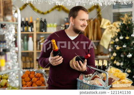 Man choosing wine in supermarket 121141130