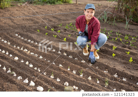 Female farmer planting seeds in the garden Female farmer planting seeds in the garden 121141323