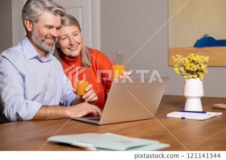 Happy mature couple at home looking contented and peaceful Happy mature couple at home looking contented and peaceful 121141344