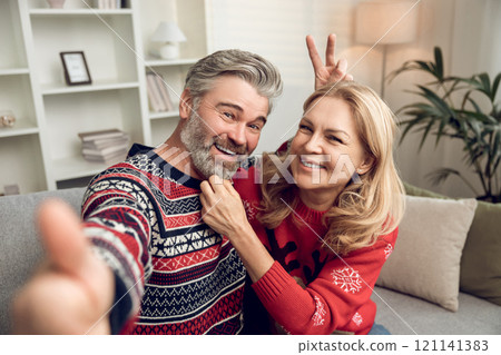 Waist up of a happy mature couple making selfie Waist up of a happy mature couple making selfie 121141383