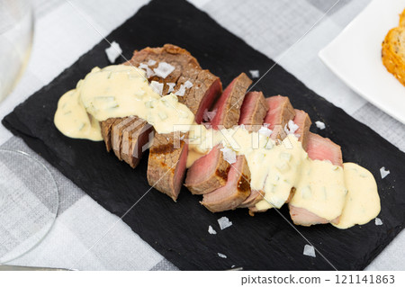 Roasted veal served with tartar sauce Roasted veal served with tartar sauce 121141863