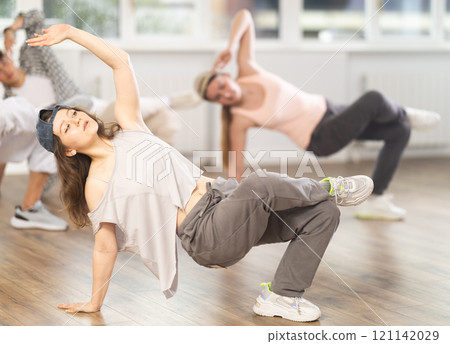 Break dance performed by a group of young dancers in dance studio 121142029