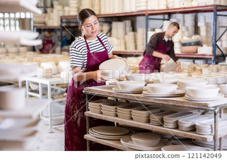 Young woman posing with ceramic blanks Young woman posing with ceramic blanks 121142049