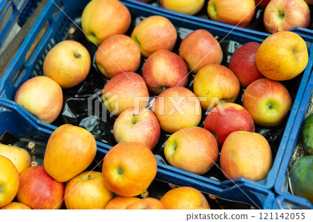 Red apple fruits are stacked in large and capacious cardboard boxes Red apple fruits are stacked in large and capacious cardboard boxes 121142055