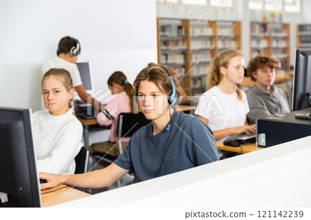 Schoolboy and schoolgirl working with computers in class room 121142239