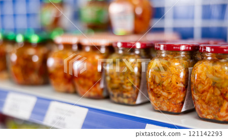 Jars of mustard stand on shelf in store Jars of mustard stand on shelf in store 121142293