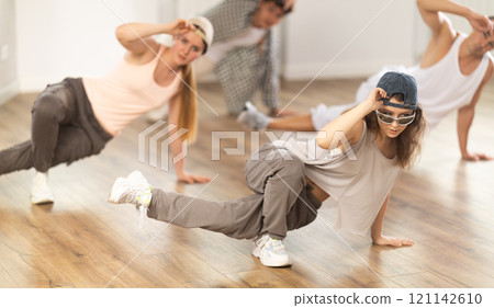Young girl practicing breakdance floor-works in training hall Young girl practicing breakdance floor-works in training hall 121142610