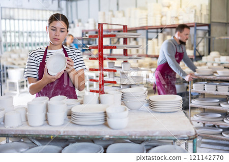 Young woman posing with ceramic blanks Young woman posing with ceramic blanks 121142770