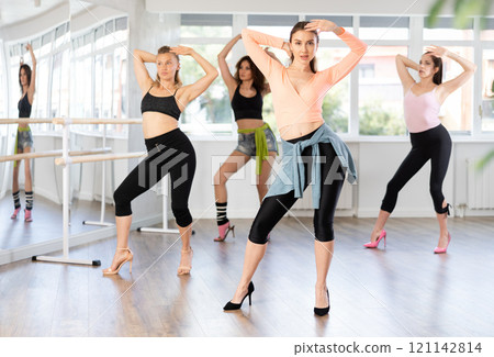 Group of women dancing high heels in studio 121142814