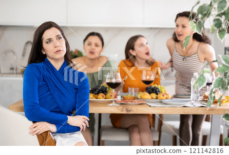 Group of women quarrel with spanish woman 121142816