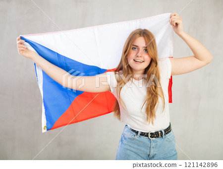 smiling girl in arms raised above head holds cloth of national flag of Czechia smiling girl in arms raised above head holds cloth of national flag of Czechia 121142896
