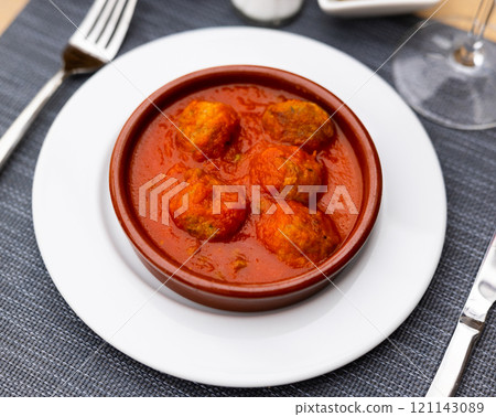 Appetizing meatballs with tomato sauce served on platter Appetizing meatballs with tomato sauce served on platter 121143089