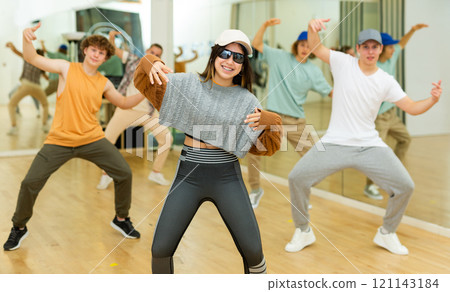 Emotional brunette teen girl dancing hip-hop with group Emotional brunette teen girl dancing hip-hop with group 121143184