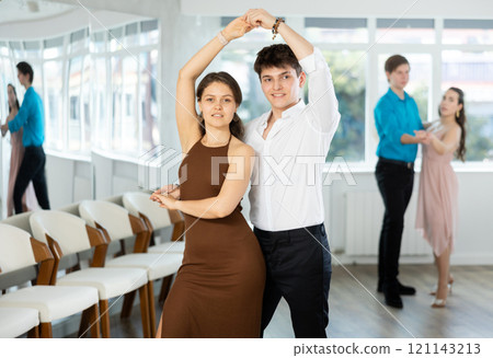 Latin American guy and girl performing kizomba in dance studio 121143213