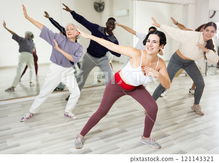Group of adult people practices dance aerobics Group of adult people practices dance aerobics 121143321