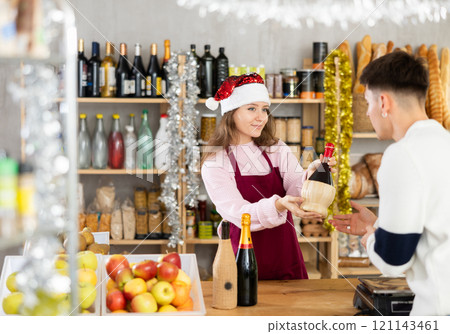 Salesgirl offering wine to customer in grocery store on New Years Eve Salesgirl offering wine to customer in grocery store on New Years Eve 121143461