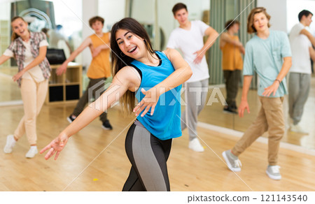 Group of teenagers rehearsing contemporary dance indoors Group of teenagers rehearsing contemporary dance indoors 121143540