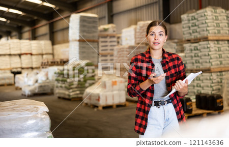 Portrait of young woman construction material storage worker 121143636