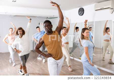 Group of different people rehearsing dance in dance studio Group of different people rehearsing dance in dance studio 121143654