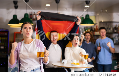 Man and woman with Germany flag drinking alcohol and having conversation on party in nightclub Man and woman with Germany flag drinking alcohol and having conversation on party in nightclub 121143656